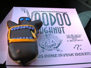 The Voodoo Doll - Raised yeast doughnut filled with raspberry jelly topped with chocolate frosting and a pretzel stake! 