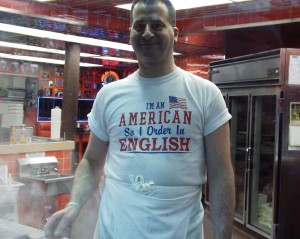 Even the cooks wear shirts about speaking in English at Geno's