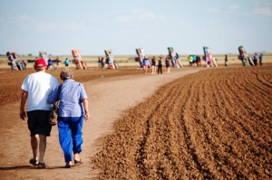 A couple walks the path to the Cadillac Ranch