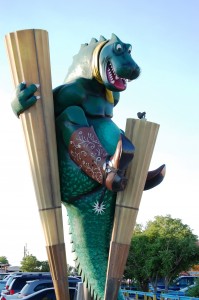 a giant green dragon in the parking lot of Big Texan