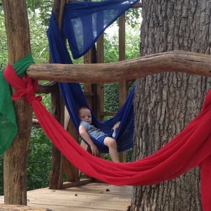Grandson Landen hangs in a canopy in the tree house