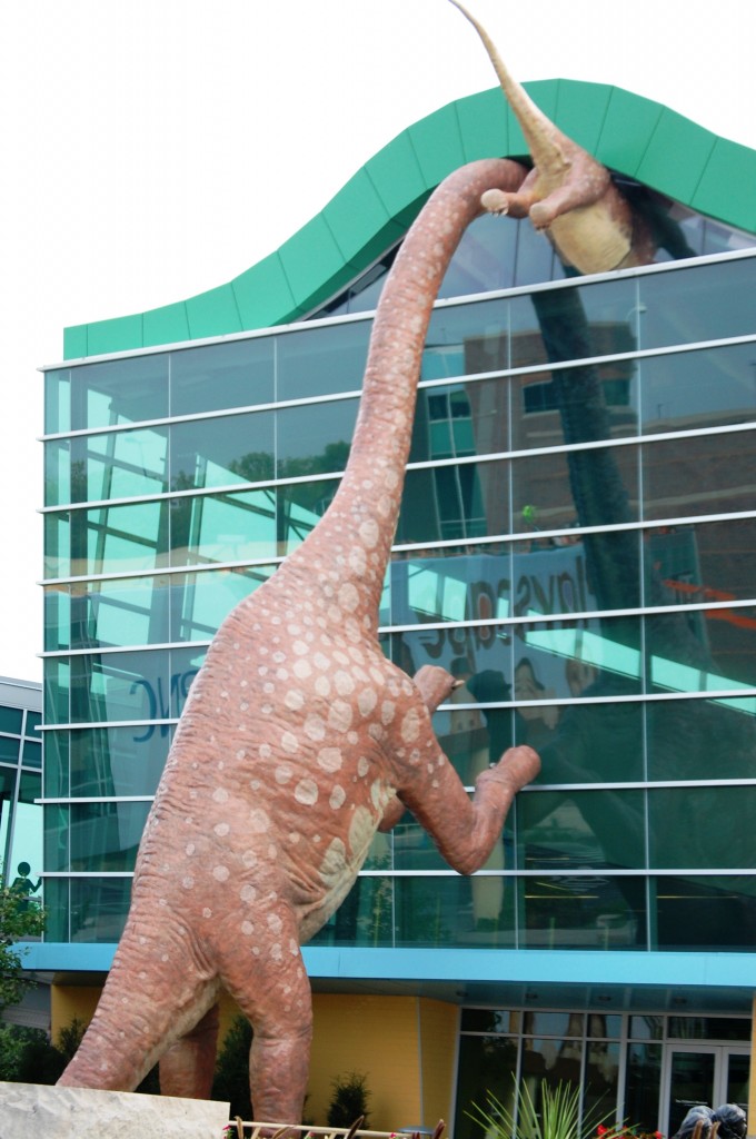 Dinosaurs peek into the Children's Museum
