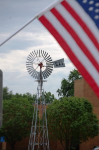 Kregel ELI Windmill framed by a flag on 9/11 in Nebraska City, Nebraska