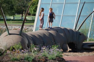 Grandkids play on the 30 foot long "Lopatapillar", a creation by artist Bob Cassilly