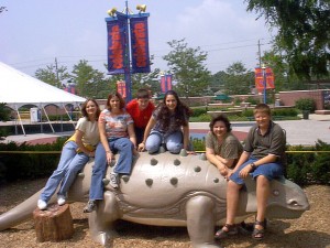 Family climbs aboard a dino at the Indianapolis Children's Museum, Summer 2000
