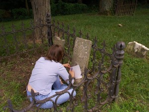 Amaree taking an etching of the grave marker of her great-great-great-great grandfather Joseph Hanks in Quincy, Illinois.