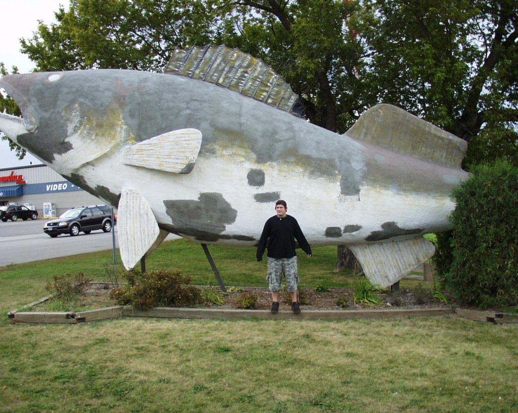 Solomon is dwarfed by the World's Largest Walleye in Baudette, MN Sept 2007