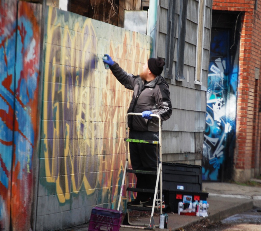 Artist at work on Graffiti wall in Northside