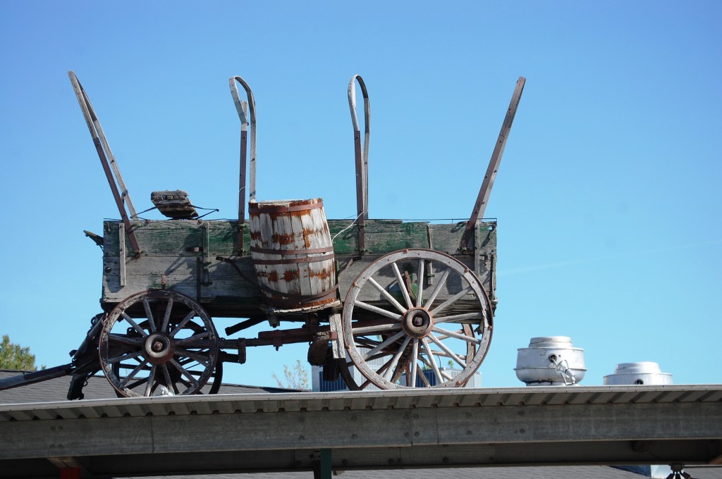 Old covered wagon on a building in Choteau, Montana