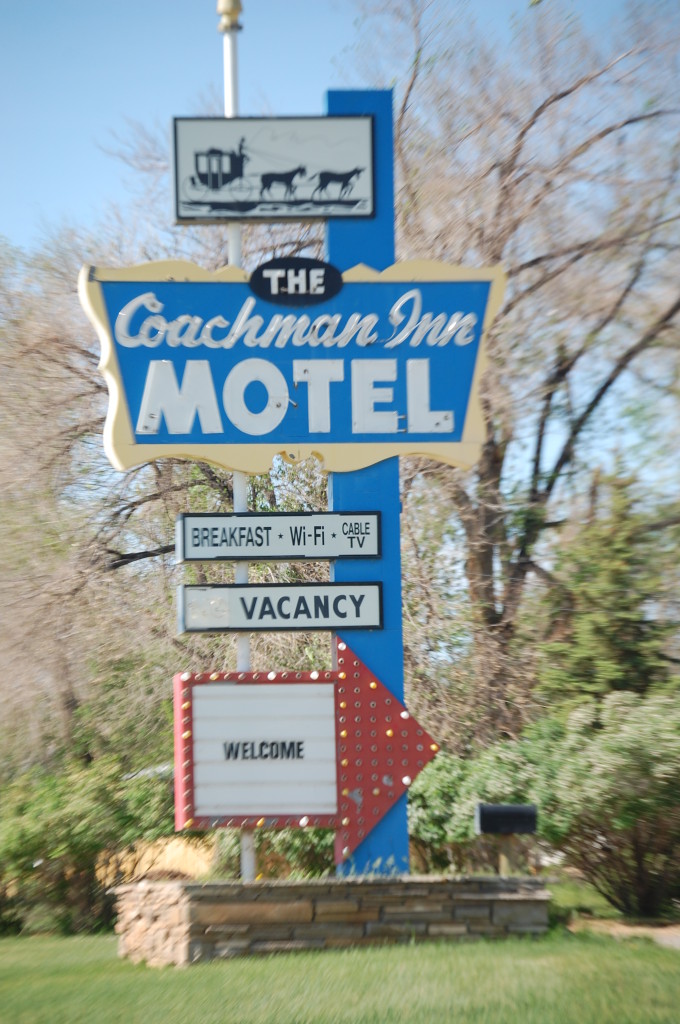 An old neon sign for the Coachman Inn