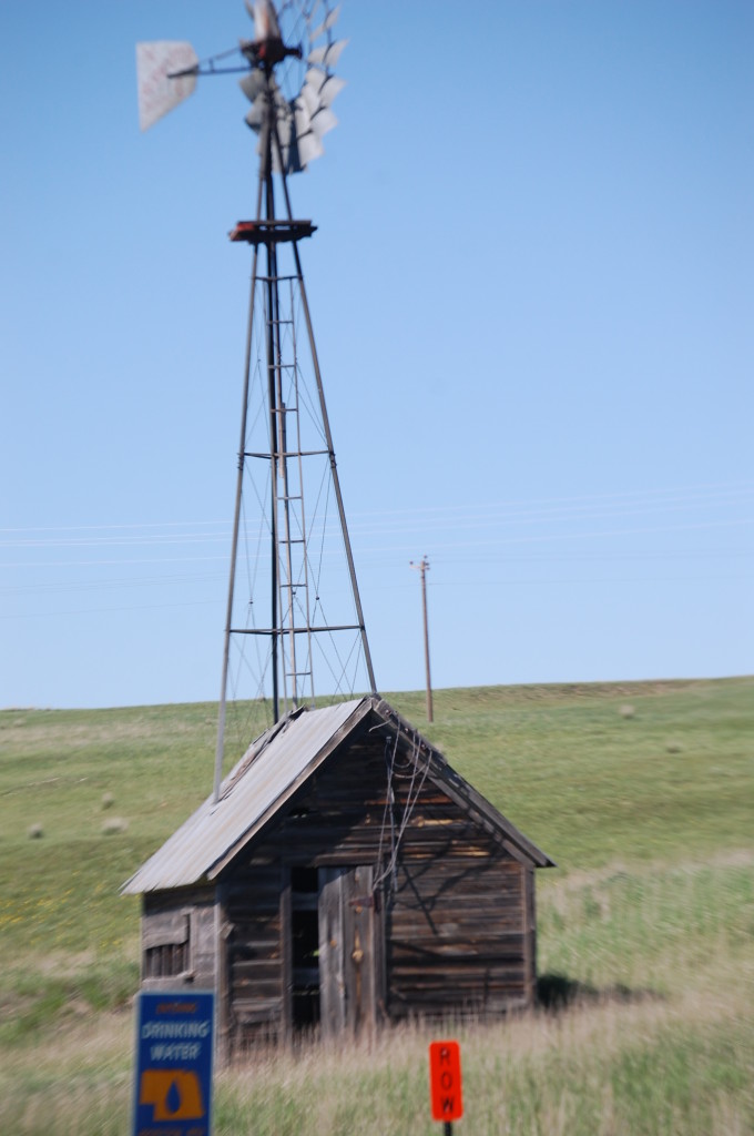 On the border, there is a building with a windmill growing out of it....