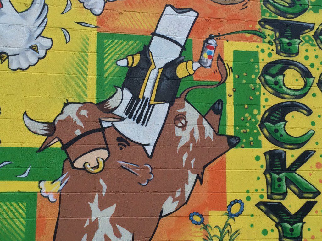 Dronex drone riding a bull, detail of "Stockyard Commons" mural