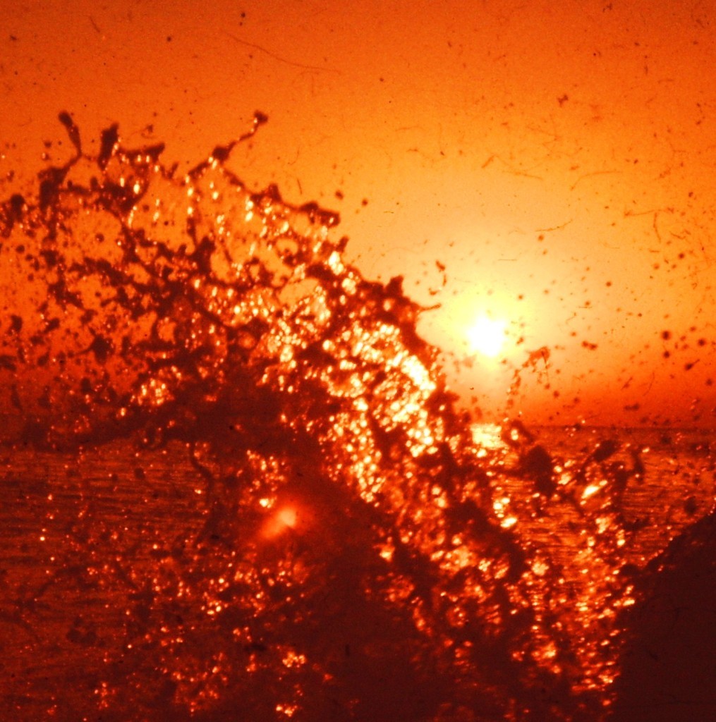 A wave splashes at sunset on the coast of the Japan Sea near Fukui (ca. 1977)