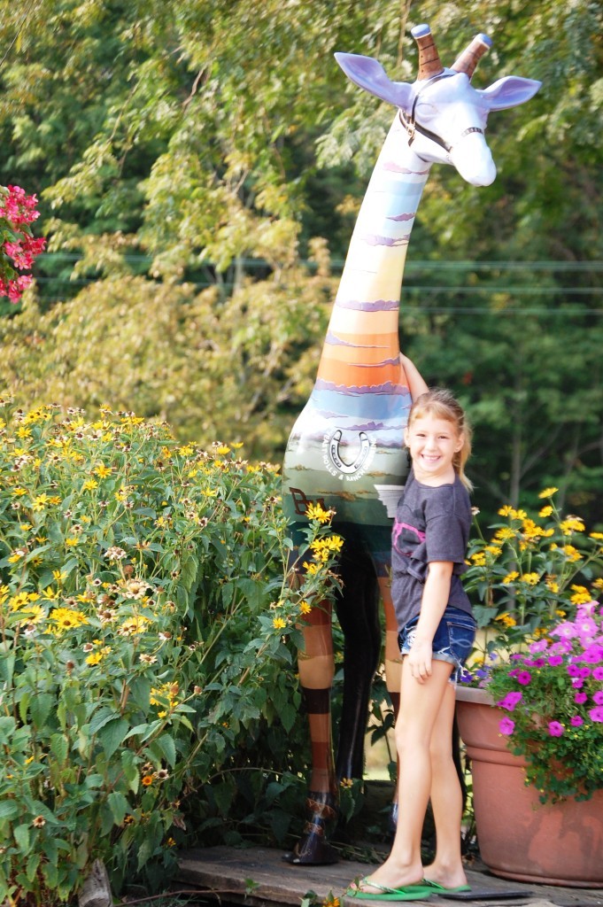 A colorful giraffe (with granddaughter) in Covington, IN