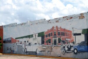 Old wall mural in Hugo depicts some of the history of the town.