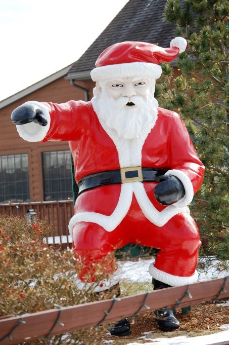 A Cranky Santa, stands about 9 feet tall
