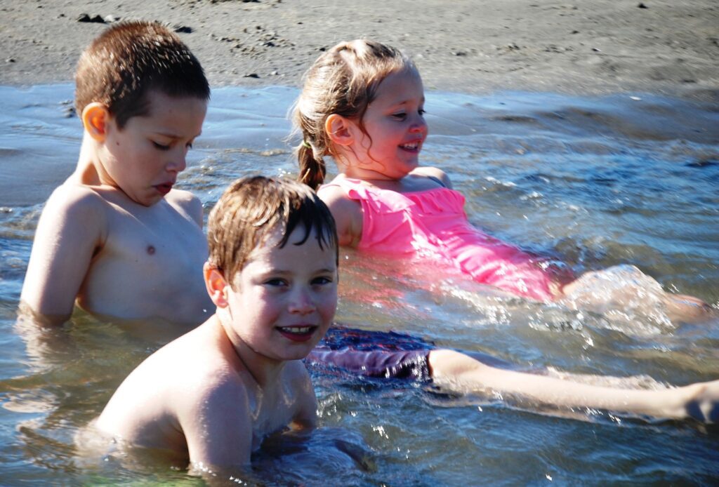 Charles, Kade and Livvy relax in a tidal pool near the Pacific Ocean