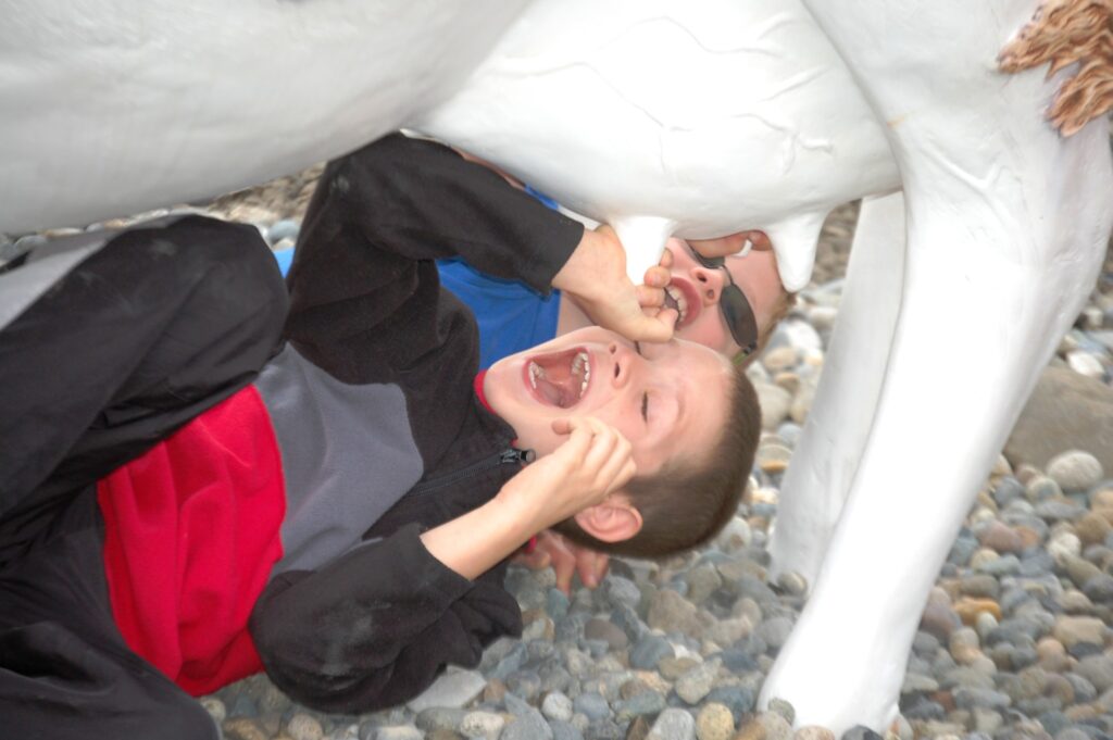 Grandsons at play with a cow...milking it for all its worth!