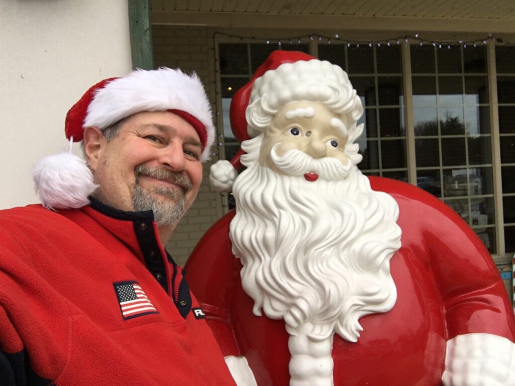 A Santa Selfie with the Santa in front of the Tourism Office