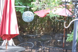 Outdoor patio seating under the decades old grapevines at Guarino's