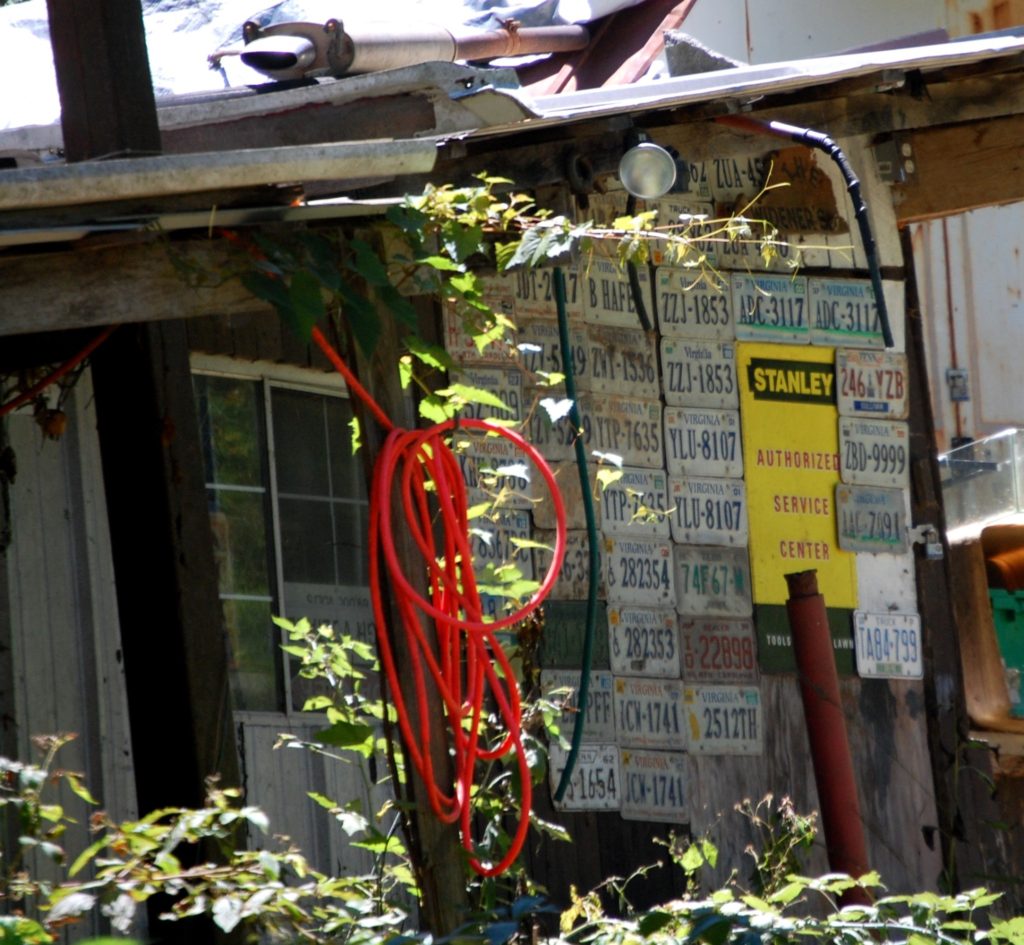 An old house with License Plate Siding. This was seen along the trail